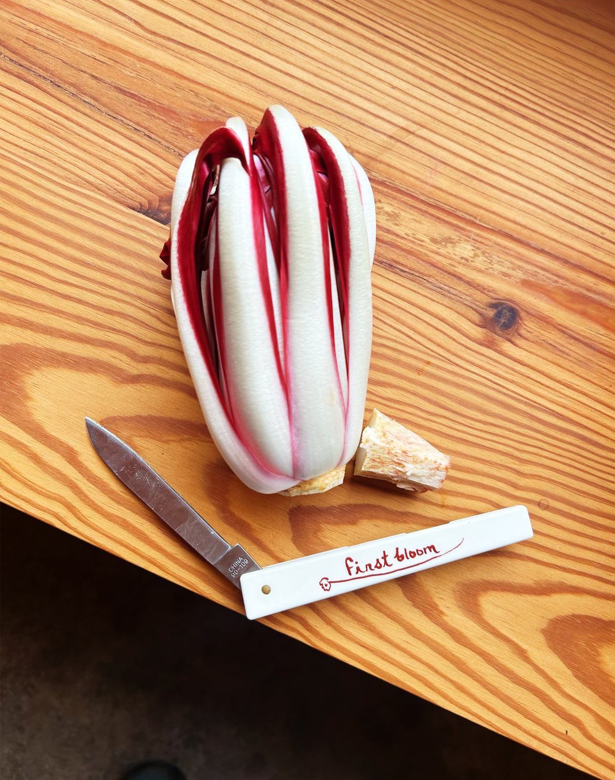 First Bloom kitchen knife on wood table