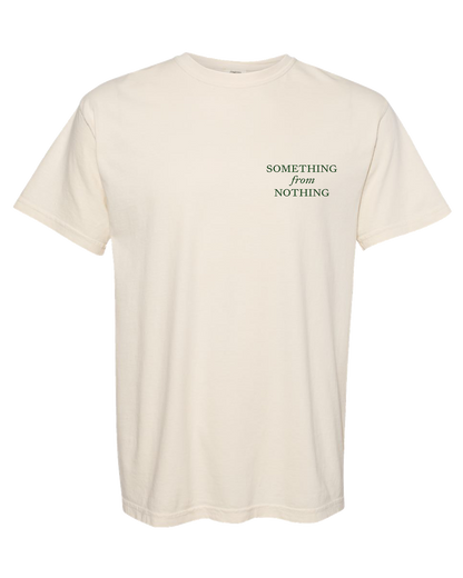 Beige t-shirt with 'SOMETHING from NOTHING' text on a white background