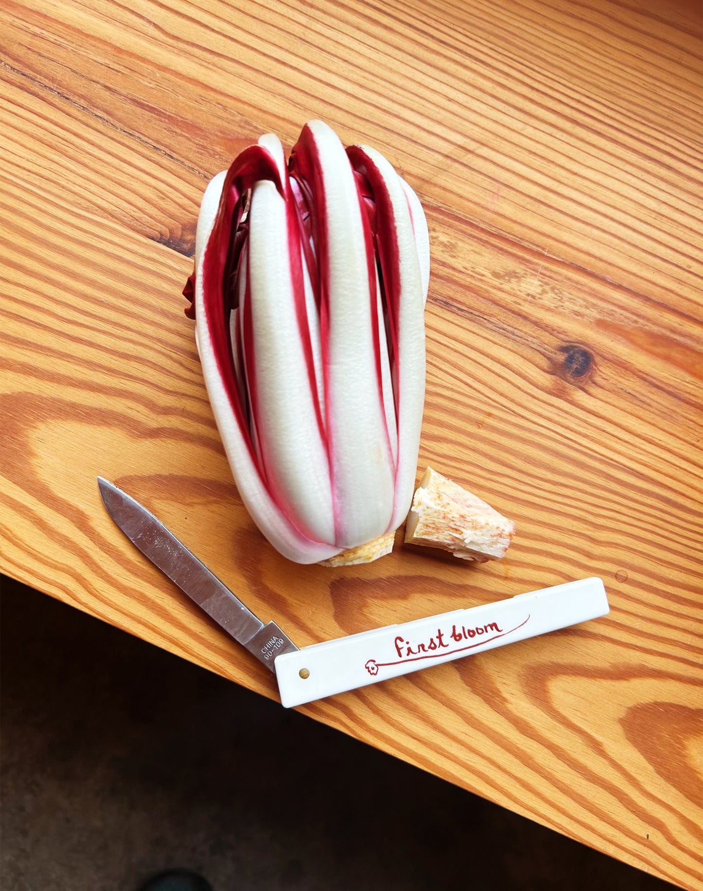 First Bloom kitchen knife on wood table