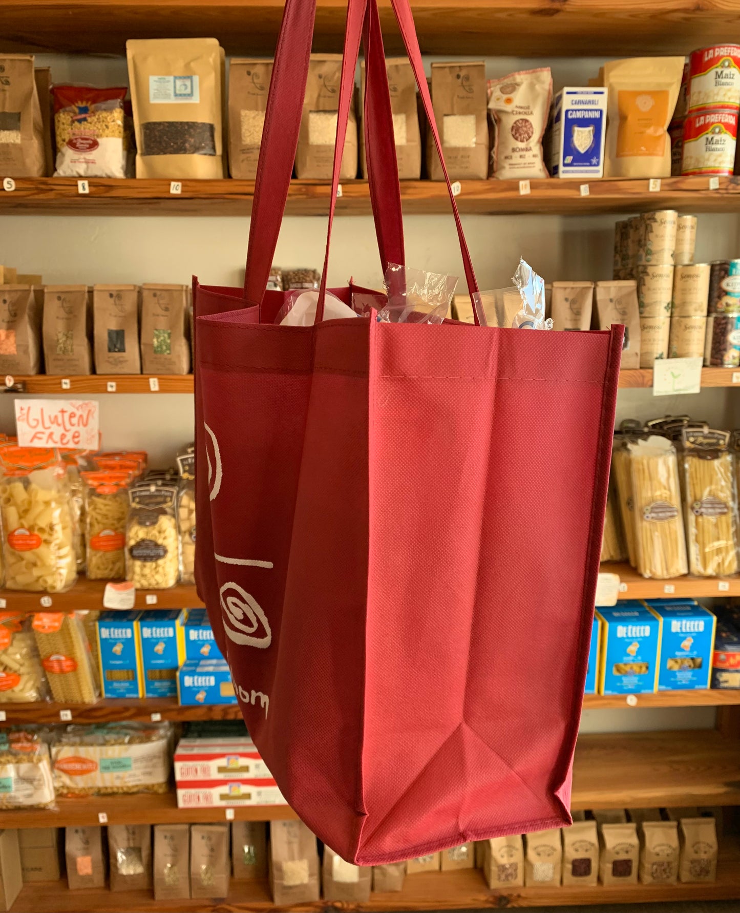 side profile of red reuseible first bloom bag