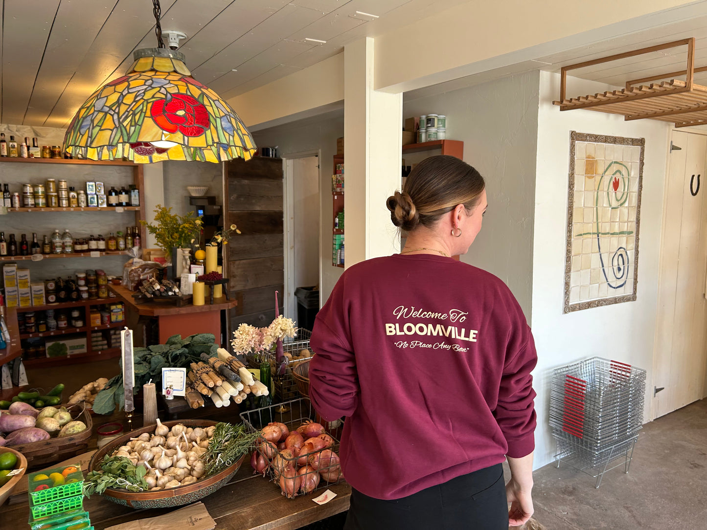 Welcome to bloomville text on back of maroon crew sweatshirt