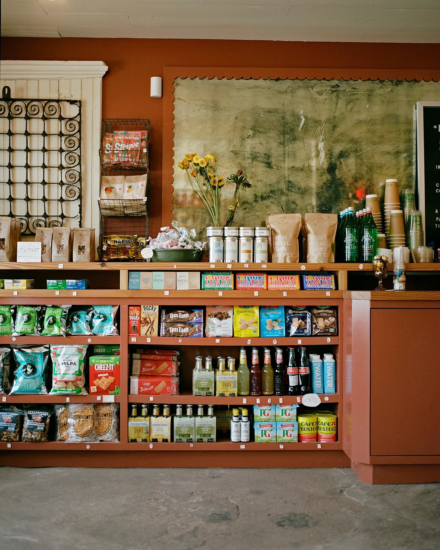 A gift card image featuring a retail environment with various products displayed on shelves in the background.